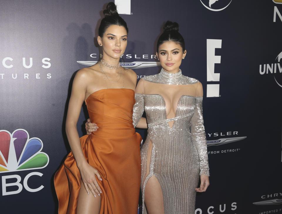 FILE - In this Jan. 8, 2017 file photo, Kendall Jenner, left, and Kylie Jenner arrive at the NBCUniversal Golden Globes afterparty at the Beverly Hilton Hotel in Beverly Hills, Calif. Kendall and Kylie Jenner were accused of exploitation in 2017 for superimposing their faces onto images of Tupac, Notorious B.I.G. and others for their line of $125 T-shirts. (Photo by Rich Fury/Invision/AP, File)