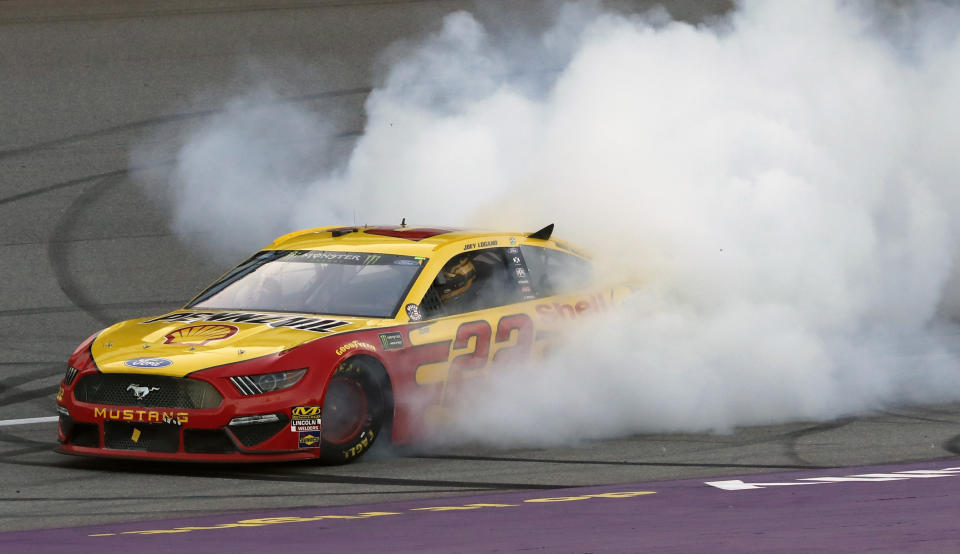 Joey Logano celebrates with a burnout after winning a NASCAR Cup Series auto race at Michigan International Speedway, Monday, June 10, 2019, in Brooklyn, Mich. (AP Photo/Carlos Osorio)