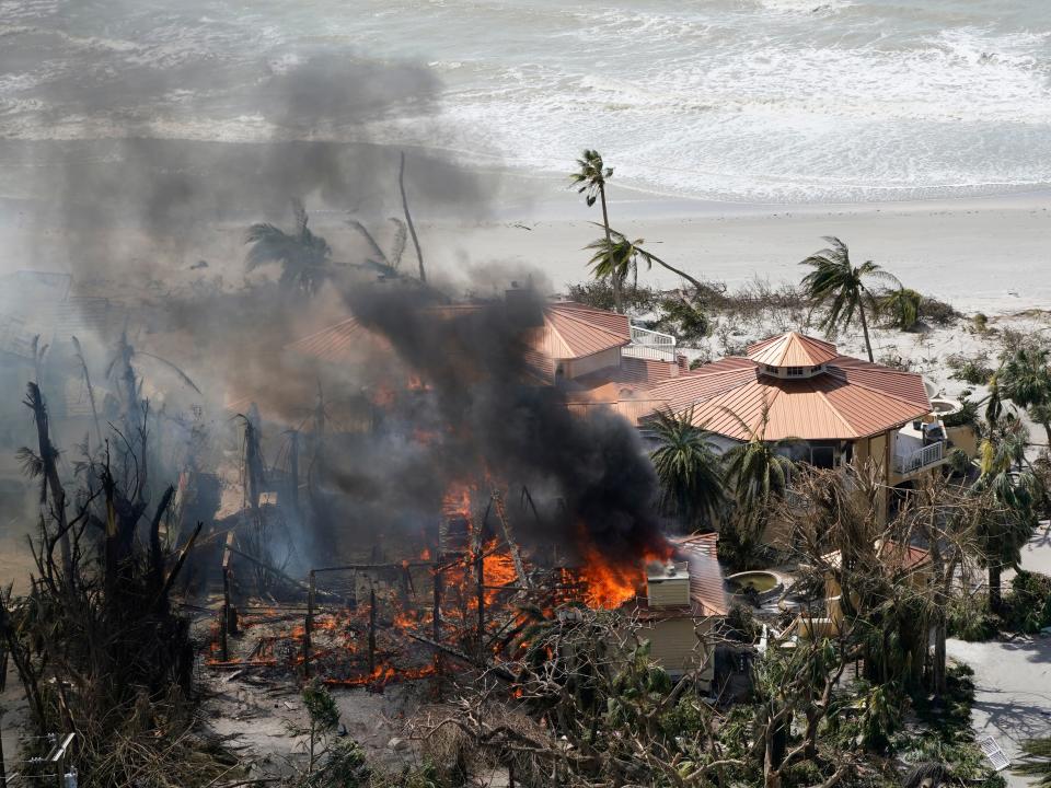 A home burns on Sanibel Island in the wake of Hurricane Ian, Thursday, Sept. 29, 2022, in Fla.