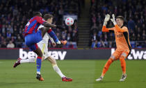 Crystal Palace's Jean-Philippe Mateta, left, tries to kick the ball over Leeds United goalkeeper Illan Meslier during the English Premier League soccer match between Crystal Palace and Leeds United at Selhurst Park, London, Monday April 25, 2022. (John Walton/PA via AP)