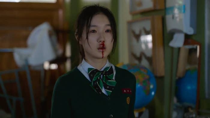 A girl bleeds from her nose as she is about to transform into a zombie