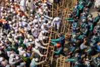 Police officers put barricades on the road to stop the march of supporters of the Islami Andolan Bangladesh in Dhaka