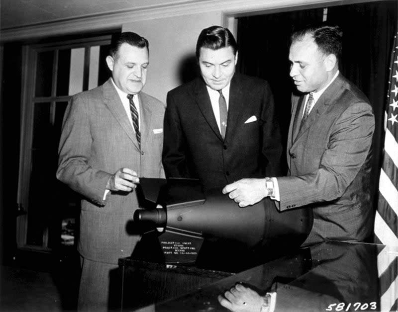 U.S. officials examine a M-388 Davy Crockett nuclear weapon. The W54 nuclear warhead was used in the man-portable M-388 Davy Crockett projectile. The unusually small size of the warhead is apparent. <em>DoD</em>