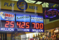 <p>Signs display the lottery prizes, Aug. 22, 2017, in Chicago. Officials estimated jackpot for Wednesday night’s Powerball lottery game has climbed to $700 million, making it the second largest in U.S. history. (Photo: G-Jun Yam/AP) </p>