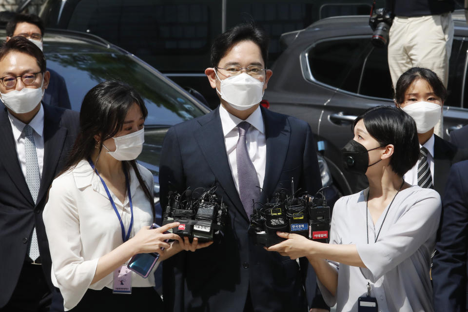 FILE - Samsung Electronics Vice Chairman Lee Jae-yong, center, arrives at the Seoul Central District Court in Seoul, South Korea, on June 8, 2020. South Korea's president will pardon billionaire Samsung heir Lee Jae-yong a year after he was released on parole after serving 18 months in prison over his involvement in a massive corruption scandal that triggered waves of protests and toppled a presidency. The decision by President Yoon Suk Yeol was announced by his justice minister on Friday, Aug. 12, 2022. (AP Photo/Ahn Young-joon. File)