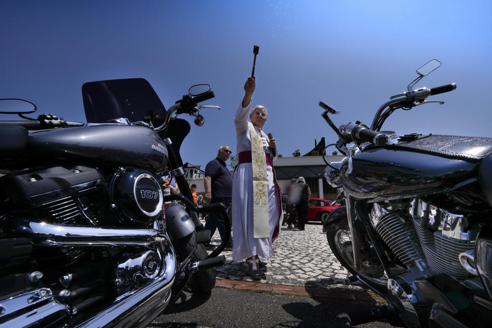 Bishop Emeritus of Sanggau, West Borneo, Giulio Mencuccini, 77, blesses the participants of a pilgrimage of bikers to the St. Gabriele dell' Addolorata sanctuary in Isola del Gran Sasso near Teramo in central Italy Sunday, June 18, 2023, after celebrating Mass for them. (AP Photo/Domenico Stinellis)