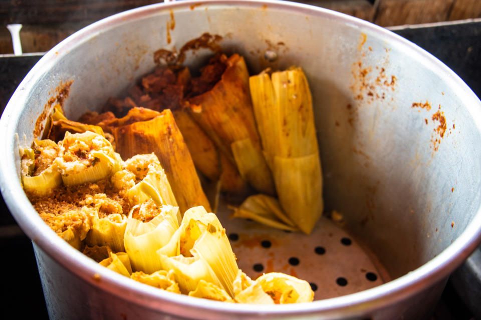 Preparing corn tamales.