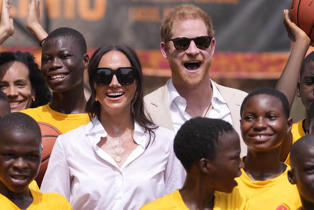 <p>AP Photo/Sunday Alamba</p> Prince Harry and Meghan, Duchess of Sussex pose for a photograph with children during the Giant of Africa Foundation at the Dream Big Basketball clinic in Lagos Nigeria, Sunday, May 12, 2024.