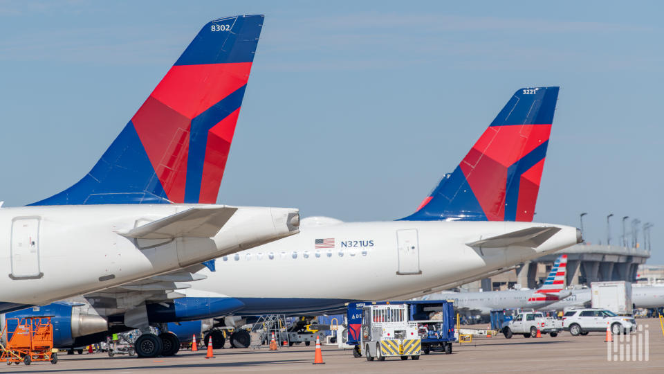 Close up two tails on aircraft painted in Delta blue and red.