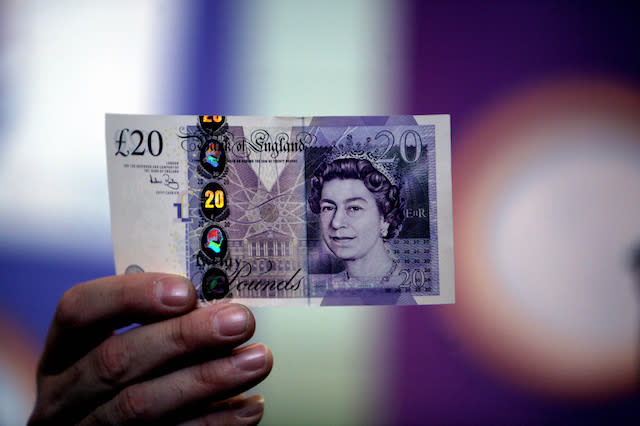 Bank of England Chief Cashier Andrew Bailey, whose name and signature appear on all new Bank of England banknotes, examines the latest Â¬Â£20 banknote at the Bank of England Museum.