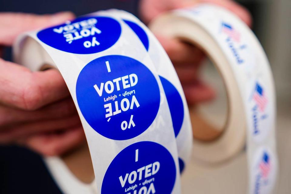 A poll worker holds voting stickers for community members Nov. 7, 2023, at Central Elementary School in Allentown, Lehigh County, Pennsylvania. Matt Smith | For Spotlight PA/For Spotlight PA