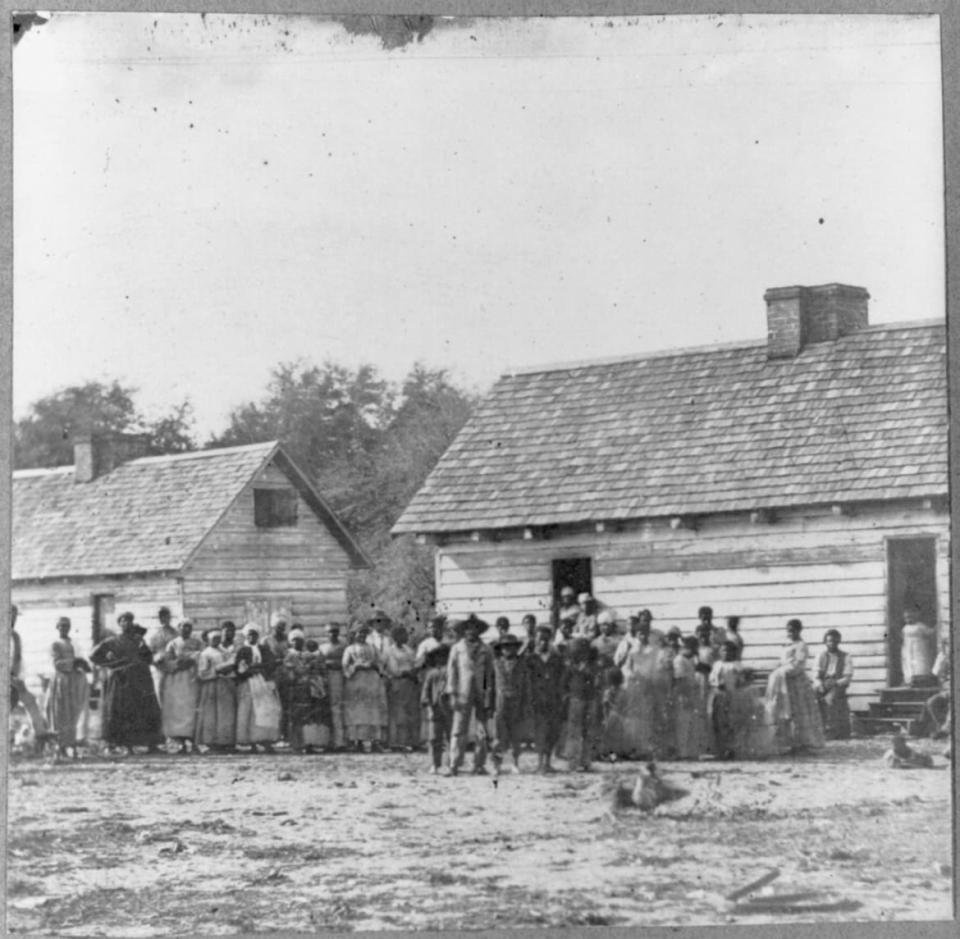 <div class="inline-image__caption"><p>A group of slaves in front of buildings on Smith's Plantation, Beaufort, South Carolina in 1862.</p></div> <div class="inline-image__credit">Library of Congress</div>