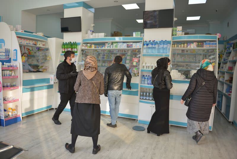 People visit a pharmacy in the Chechen capital Grozny