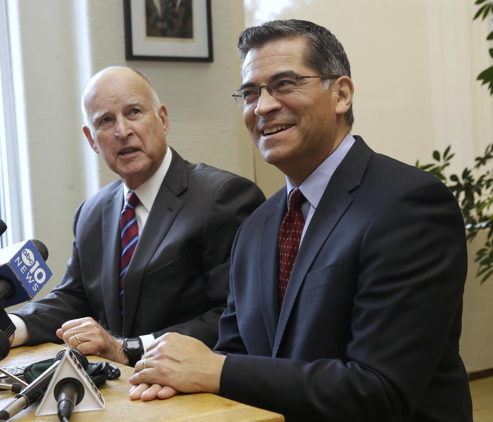 FILE - In this Dec. 5, 2016 file photo, California Gov. Jerry Brown, left, answers a reporter's question during a news conference with his attorney general nominee Rep. Xavier Becerra, D-Calif., in Sacramento, Calif. As the most populous state’s first Latino attorney general, Becerra is uniquely positioned to oppose the Trump administration’s immigration crackdown. (AP Photo/Rich Pedroncelli, File)