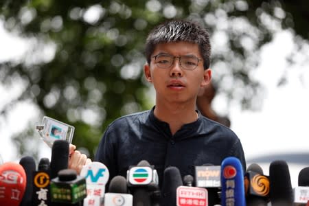 Hong Kong democracy activist Joshua Wong speaks outside the Legislative Council building in Hong Kong