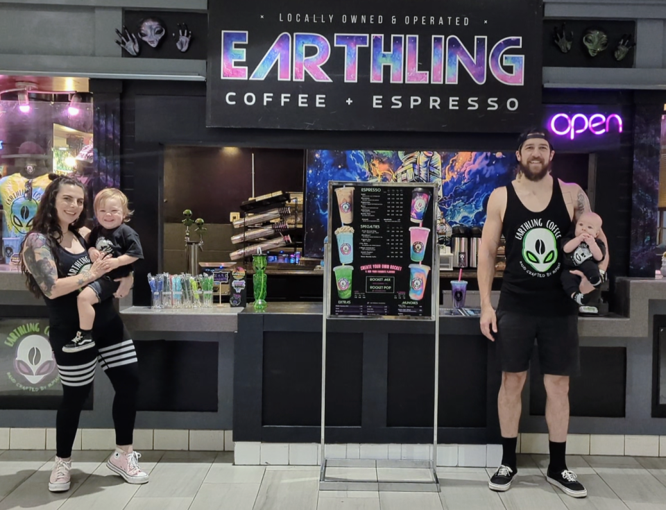 Earthling Coffee and Espresso owners Jaimi and Chris Gunkel with their children in front of their new coffee shop location at Asheville Mall.