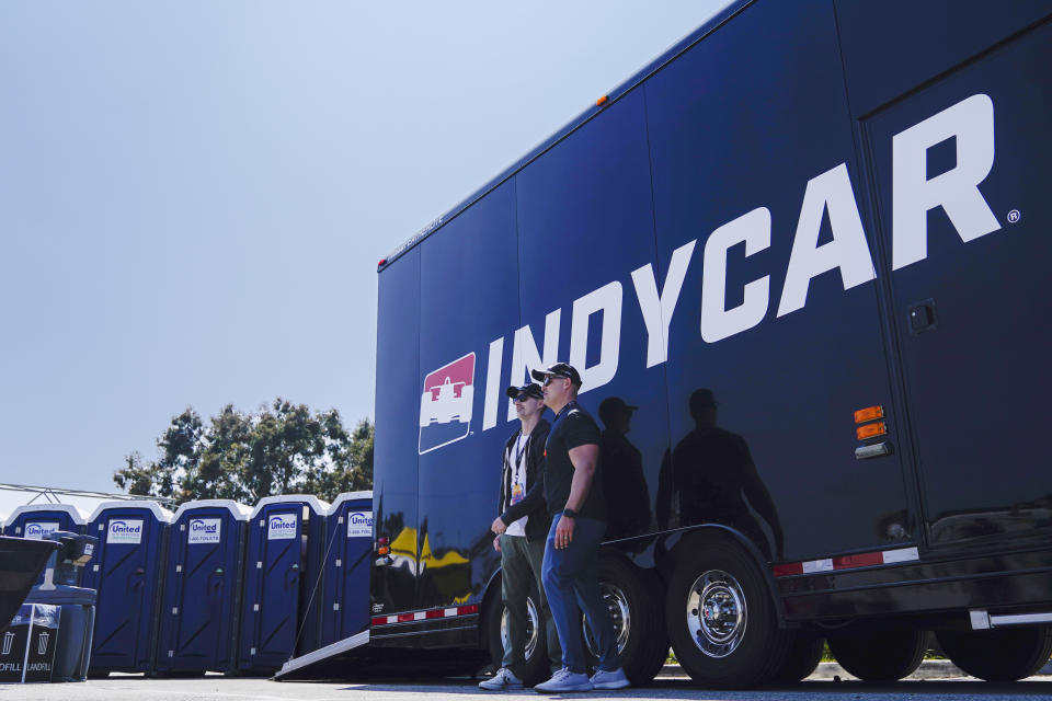 Fans take a photo in front of an IndyCar logo after a qualifying session for the IndyCar Grand Prix of Long Beach auto race Saturday, April 20, 2024, in Long Beach, Calif. (AP Photo/Ryan Sun)