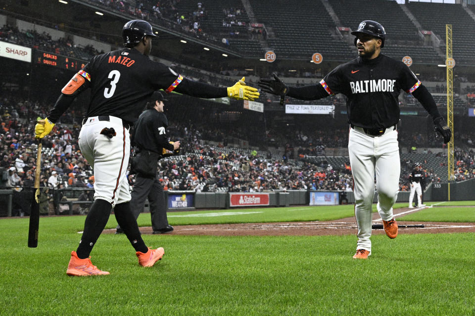 Baltimore Orioles' Anthony Santander, right, is greeted by Jorge Mateo (3) after scoring on a groundout by Cedric Mullins during the second inning of a baseball game against the Arizona Diamondbacks, Friday, May 10, 2024, in Baltimore. (AP Photo/Nick Wass)