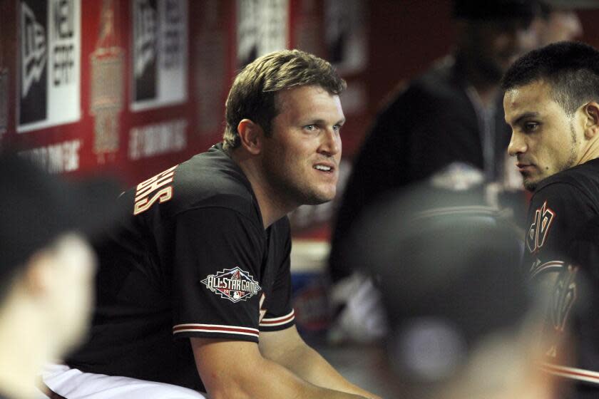 Arizona Diamondbacks' Sean Burroughs, left, and Gerardo Parra chat in the dugout