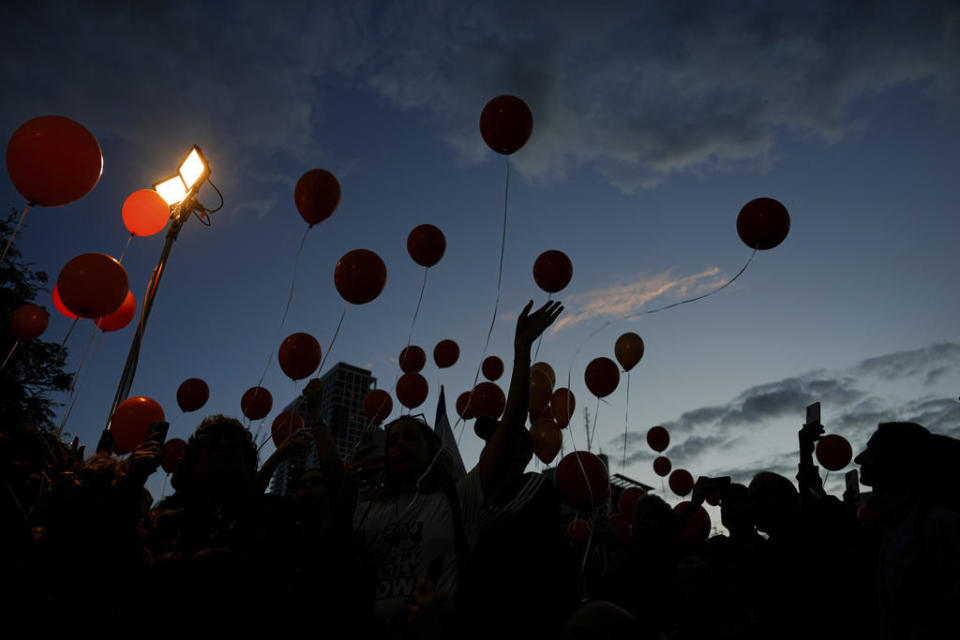 Protesters released balloons as they called for the release of the Bibas family, in Tel Aviv, Tuesday, Nov. 28, 2023.  / Credit: Ariel Schalit/AP