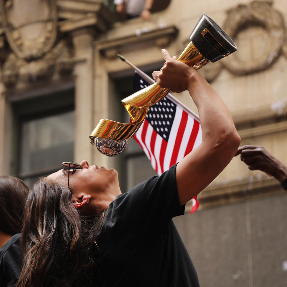 Alex Morgan celebrates with the trophy while riding on a float during the U.S. Women's National Soccer Team Victory Parade down the Canyon of Heroes on July 10, 2019 in New York City. The team defeated the Netherlands 2-0 Sunday in France to win the 2019 Women's World Cup. (Photo by Spencer Platt/Getty Images)