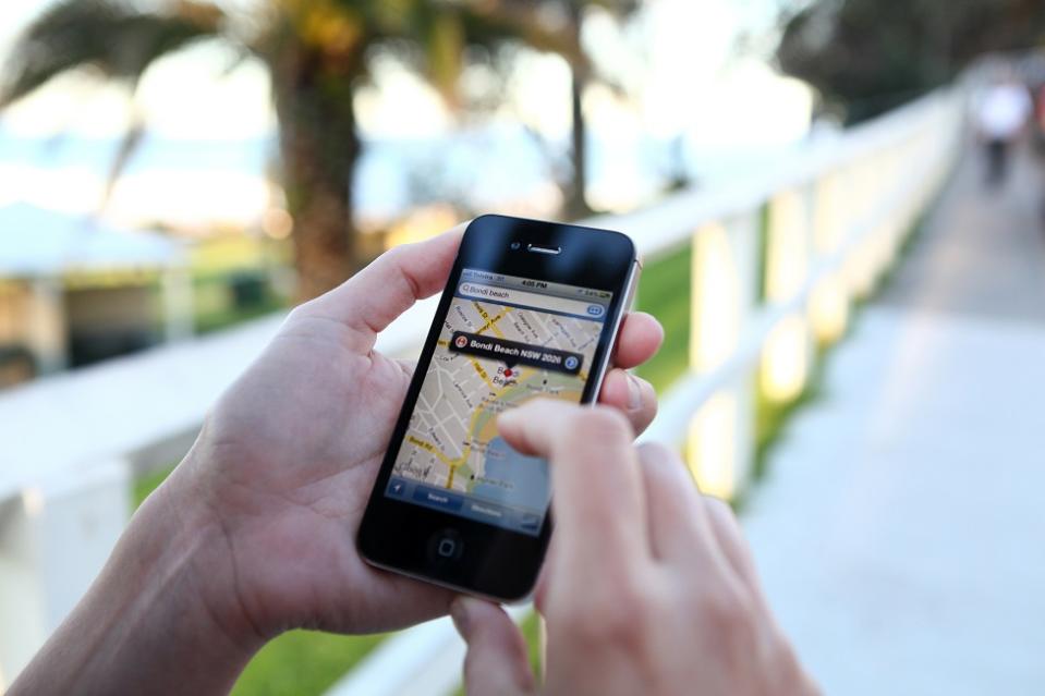 Una mujer con su celular viendo Google Maps