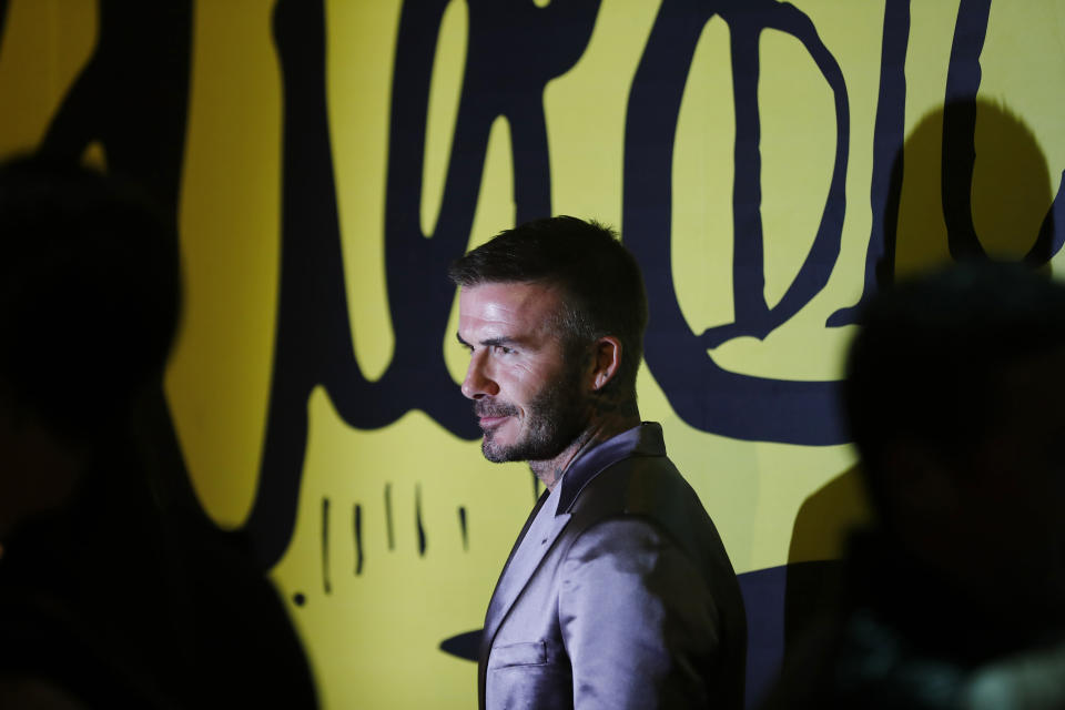 David Beckham poses for a photograph before a Christian Dior pre-fall 2020 men's fashion collection presentation during Art Basel on Tuesday, Dec. 3, 2019, in Miami. (AP Photo/Brynn Anderson)