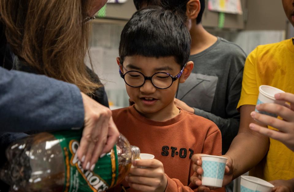 Mary Goetz, a fourth grade teacher at Bemis Elementary School, pours Vernors for her student Thomas Jeong inside their classroom in Troy on Wednesday, March 1, 2023.