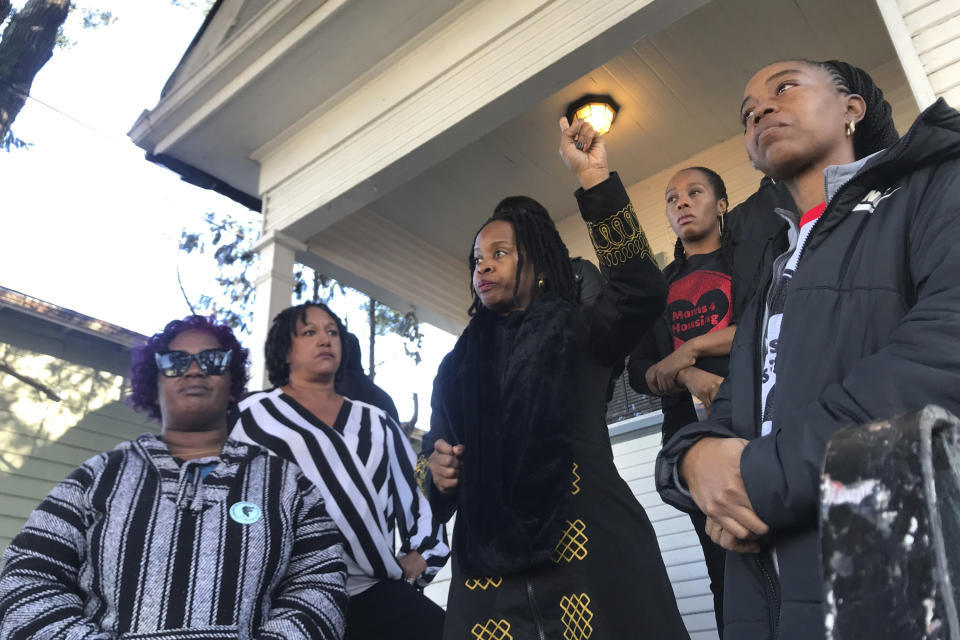 In this Dec. 30, 2019, file photo, Sharena Thomas, left, Carroll Fife, center, Dominique Walker, second from right, and Tolani KIng, right, stand outside a vacant home they took over on Magnolia Street in West Oakland, Calif. | Kate Wolffe—KQED/AP