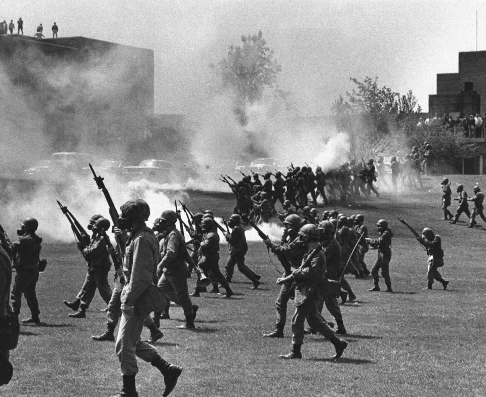 FILE - In this May 4, 1970 file photo, Ohio National Guard soldiers move in on war protestors at Kent State University in Kent, Ohio. Four persons were killed and multiple people were wounded when National Guardsmen opened fire. The school, about 30 miles southeast of downtown Cleveland, had planned an elaborate multi-day commemoration for the 50th anniversary Monday, May 4, 2020. The events were canceled because of social distancing restrictions amid the coronavirus pandemic. Some events, activities and resources are being made available online. (AP Photo, File)