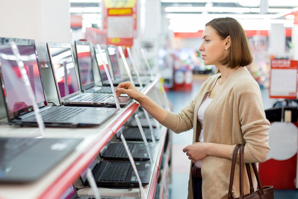 woman chooses the laptop