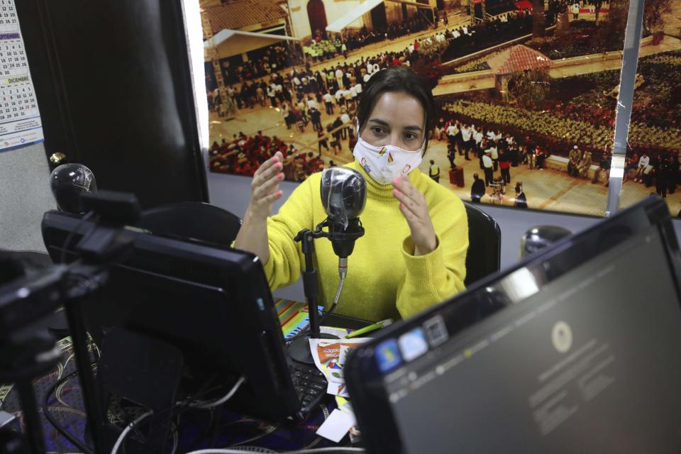 Diana Lopez imparts a one-hour class through Bacata Stereo radio station during the lockdown to prevent the spread of the new coronavirus in Funza, Colombia, Wednesday, May 13, 2020. While schools are closed during the lockdown to curb the spread of COVID-19, teachers in the municipality of Funza broadcast their lessons through the radio station because many students do not have access to the Internet. (AP Photo/Fernando Vergara)