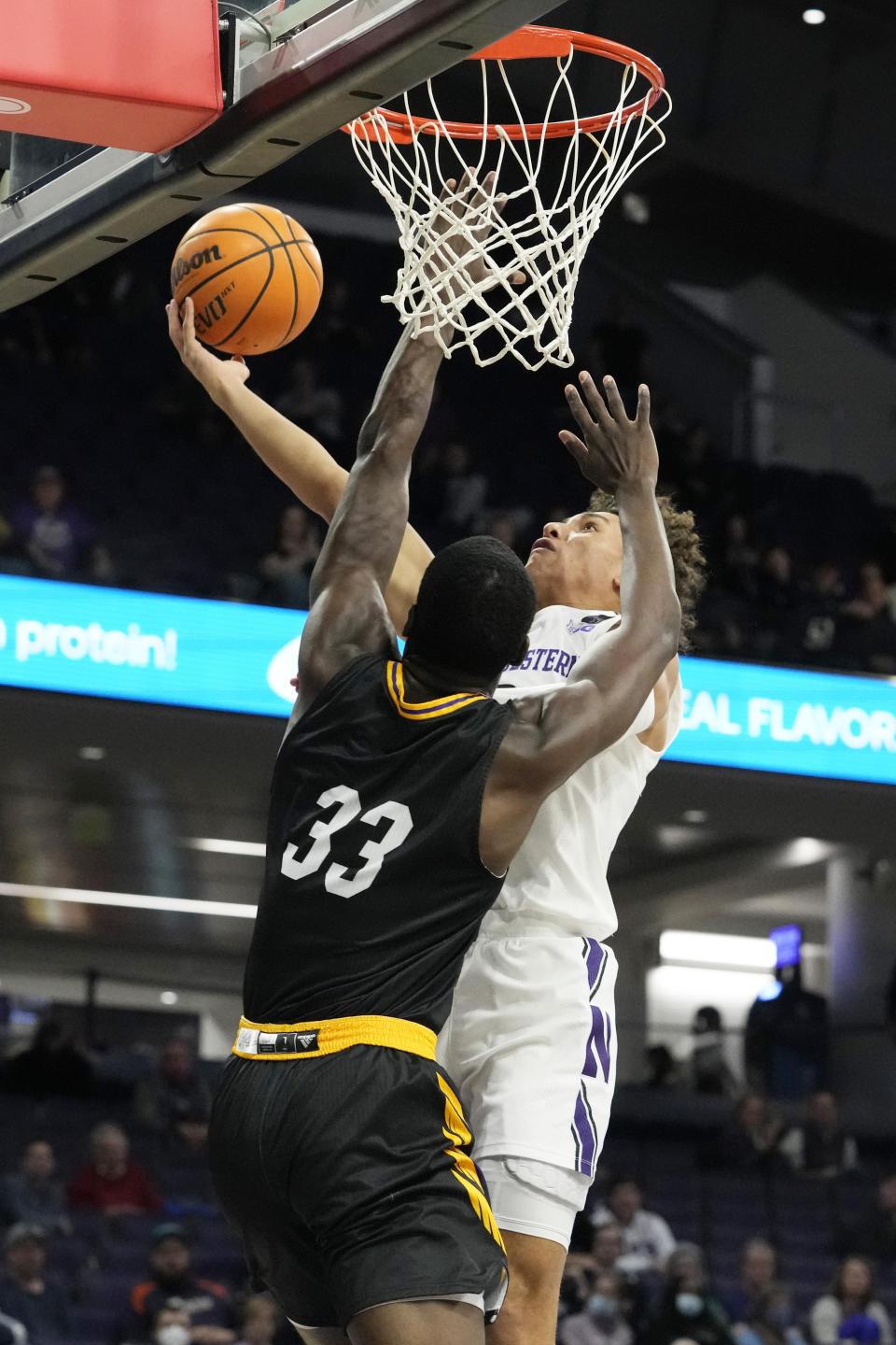 Northwestern guard Ty Berry, right, drives to the basket against Prairie View A&M forward Mckinley Harris during the second half of an NCAA college basketball game in Evanston, Ill., Sunday, Dec. 11, 2022. Northwestern won 61-51. (AP Photo/Nam Y. Huh)