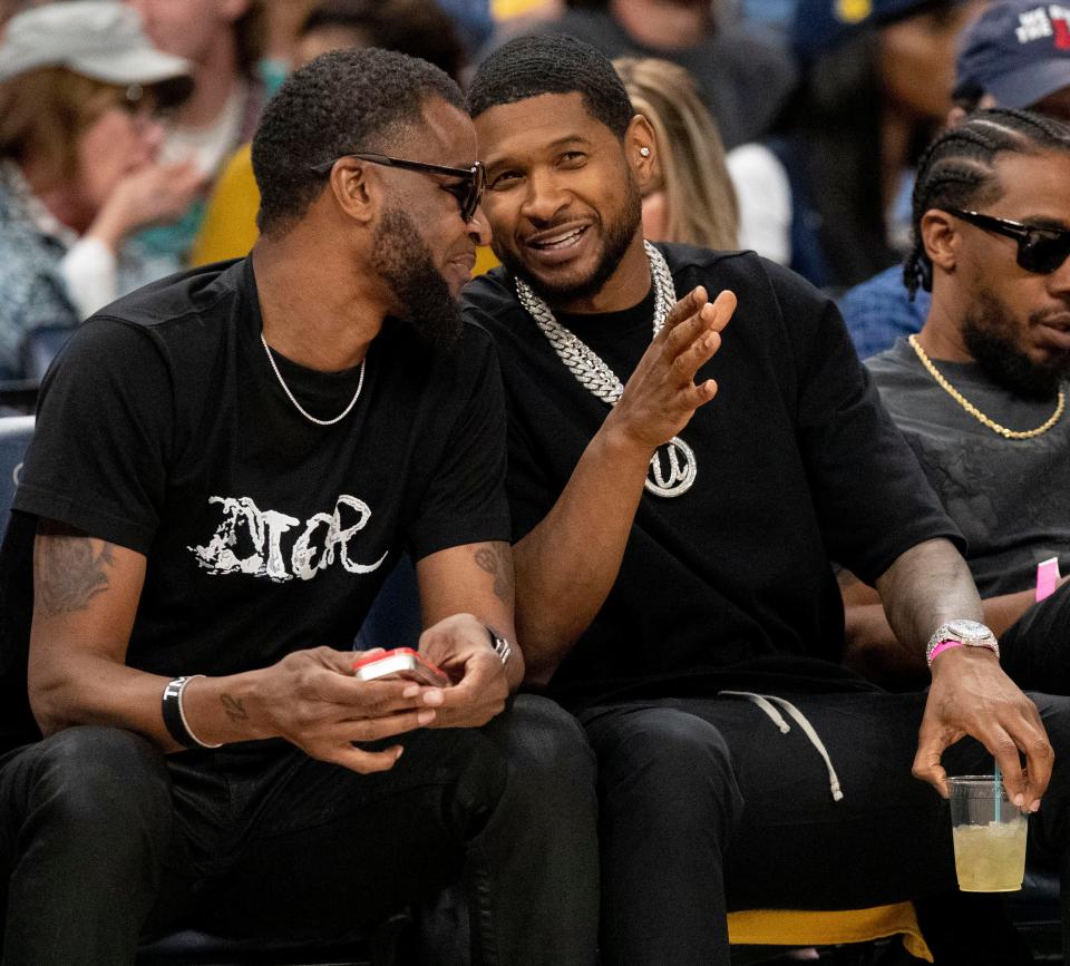 Apr 26, 2022; Memphis, Tennessee, USA; Usher sits courtside next to Tee Morant during the first half of game five of the first round for the 2022 NBA playoffs between the Memphis Grizzlies and Minnesota Timberwolves at FedExForum. Mandatory Credit: Christine Tannous-USA TODAY Sports