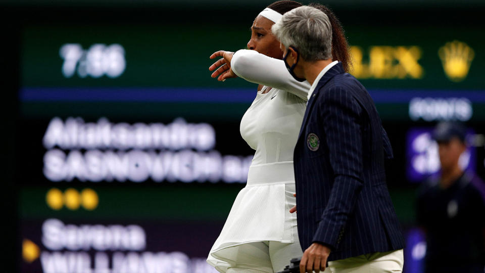 A distraught Serena Williams speaks with a Wimbledon official after suffering an injury in her first round match.