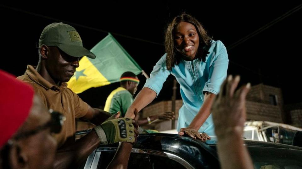 Presidential candidate and founder of the Alternative pour la relève citoyenne (ARC) party, Anta Babacar Ngom, greets supporters in the Hann Mariste district of Dakar.