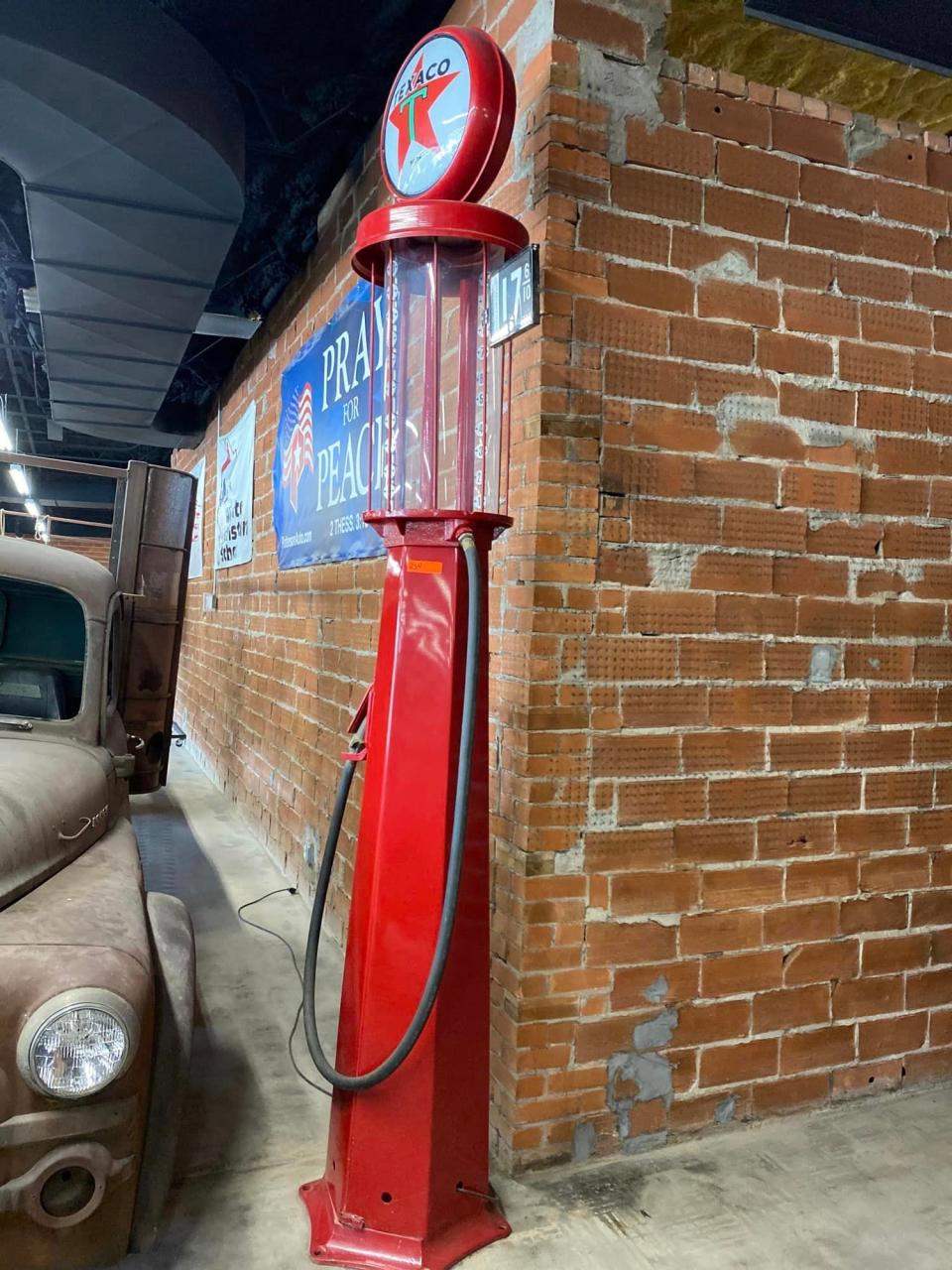 An early day gasoline pump will be among items sold this month at Harry Patterson's Crazy Cars Museum.