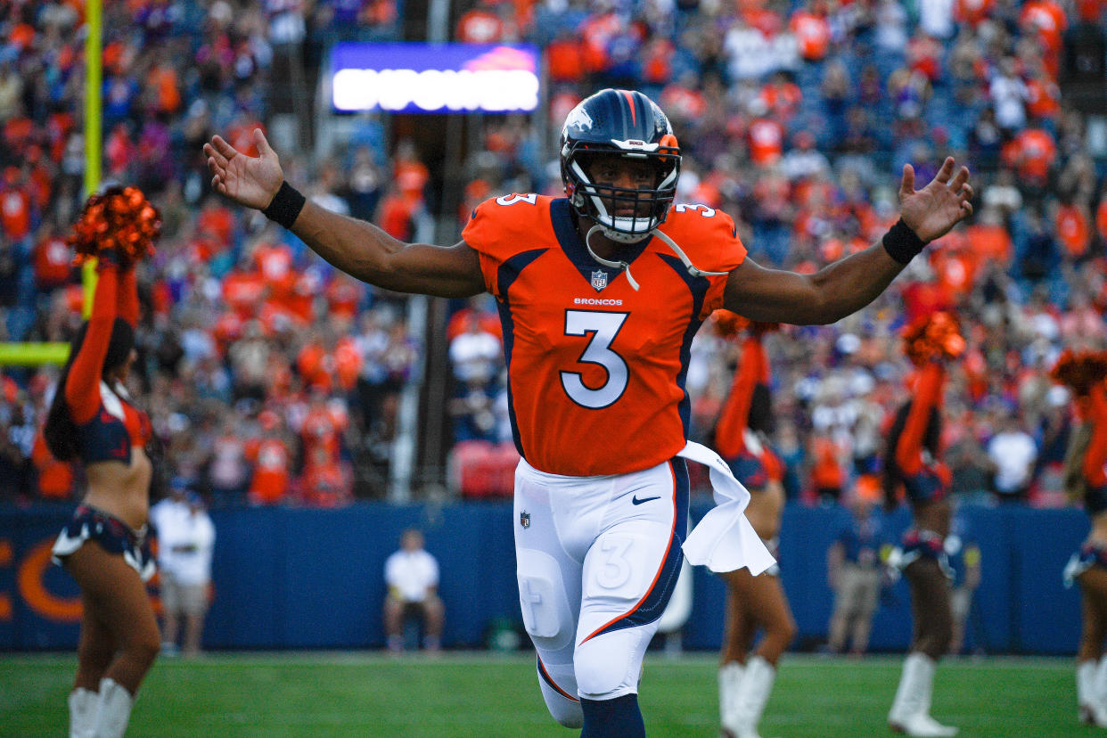 Denver Broncos QB Russell Wilson runs onto the field before a preseason game against the Minnesota Vikings on Aug. 27. (Dustin Bradford/Getty Images)