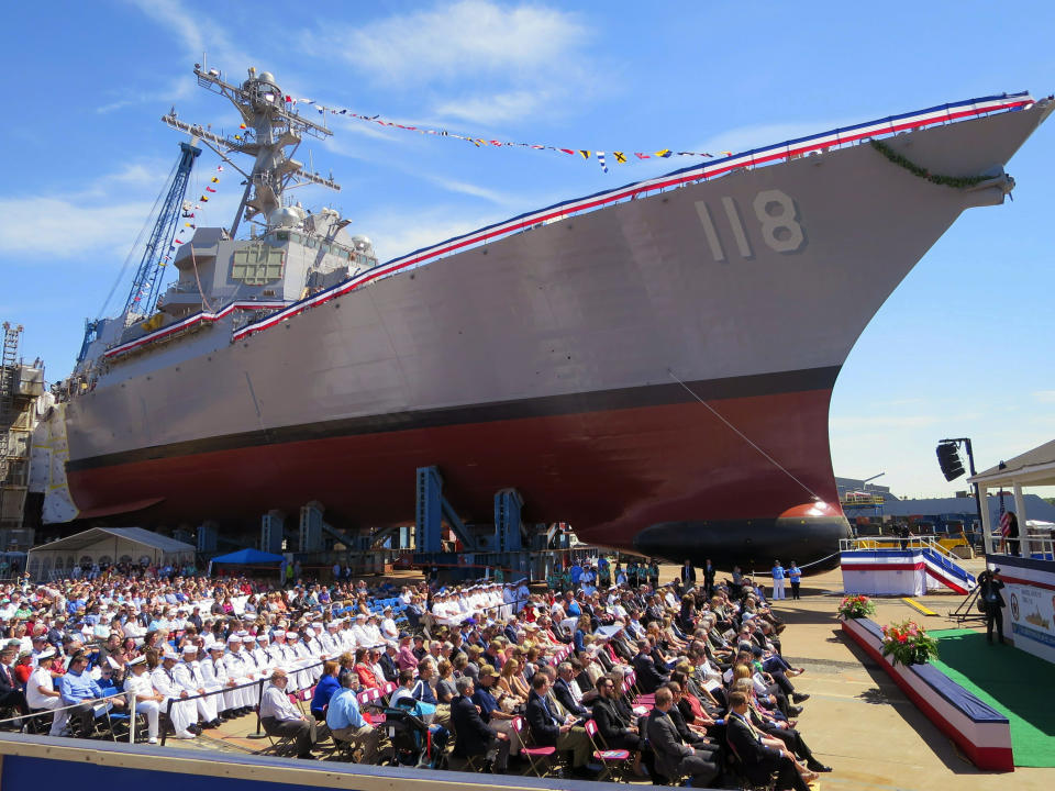 A crowd including Navy sailors in white uniforms attend the christening ceremony for the future USS Daniel Inouye at shipbuilder Bath Iron Works on Saturday, June 22, in Bath, Maine. Inouye, the ship's namesake, was a Medal of Honor recipient who broke racial barriers and represented Hawaii in the U.S. Senate for a half-century until his death in 2012. (AP Photo/David Sharp)