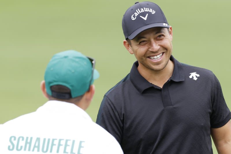 Xander Schauffele (R) arrives on the practice tee two days before the start of the Masters Tournament on Tuesday at Augusta National Golf Club in Augusta, Ga. Photo by John Angelillo/UPI