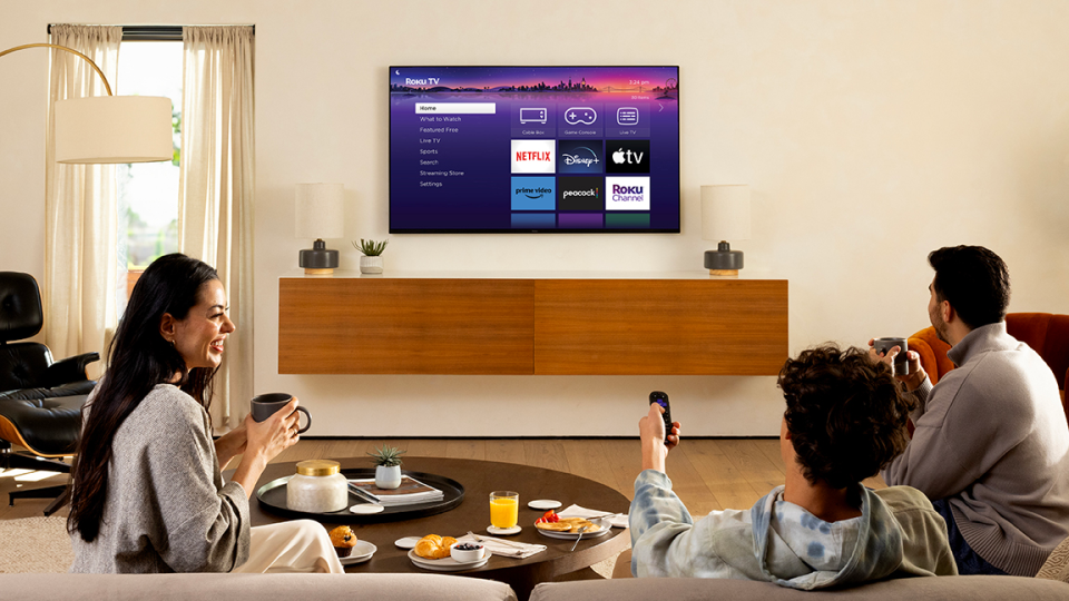 A family watching a Roku Pro Series TV