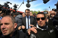 <p>French centrist presidential election candidate Emmanuel Macron, center, makes his way at the Whirlpool home appliance factory, Wednesday April 26, 2017 in Amiens, northern France. Far-right French presidential candidate Marine Le Pen has earlier upstaged Macron as she made a surprise campaign stop to the plant. (AP Photo/Thibault Camus) </p>