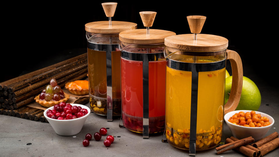 A French press being used for fruit juice