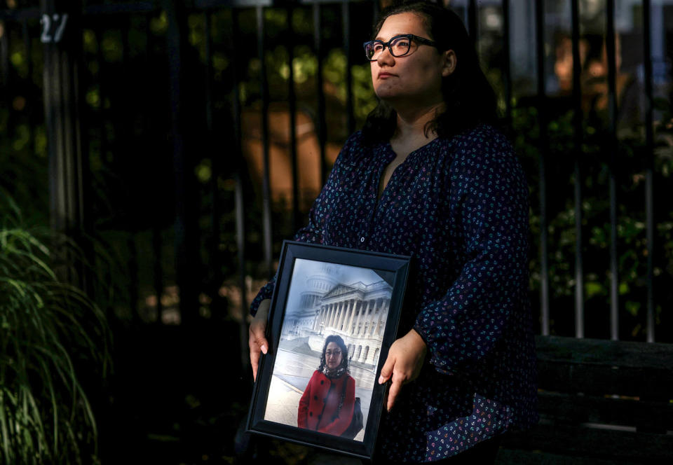 Ziba Murat holds a photo of her mother Gulshan Abbas in Virginia on June 16, 2021. (Leah Millis / Reuters file)