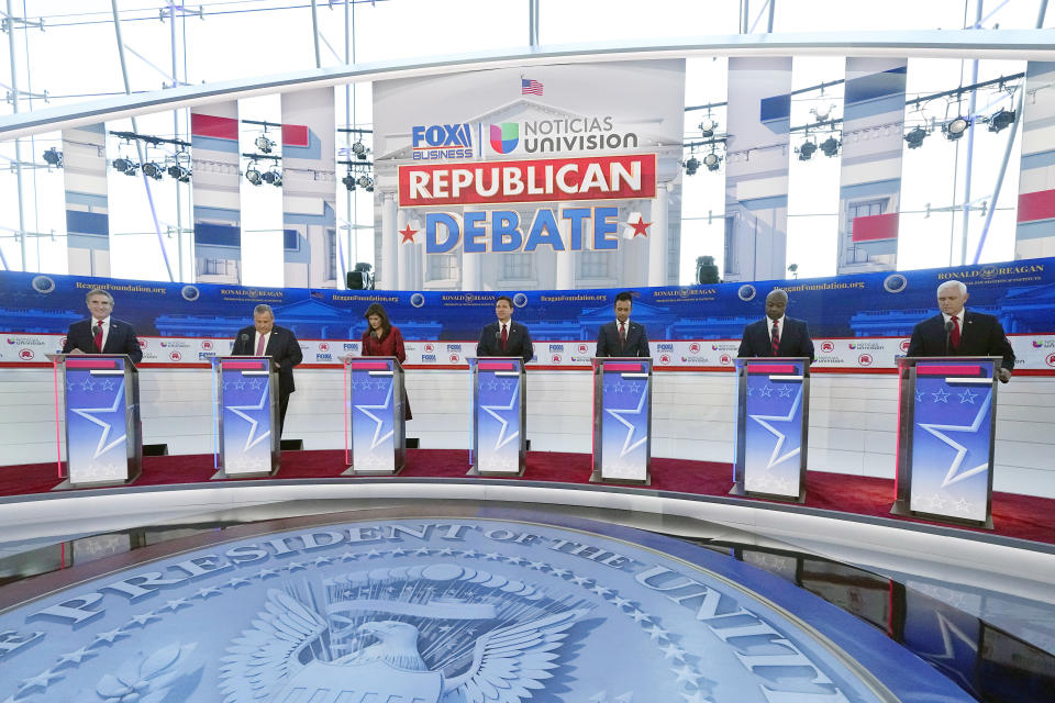 Republican presidential candidates stand at their podiums onstage during the second Republican presidential primary debate.