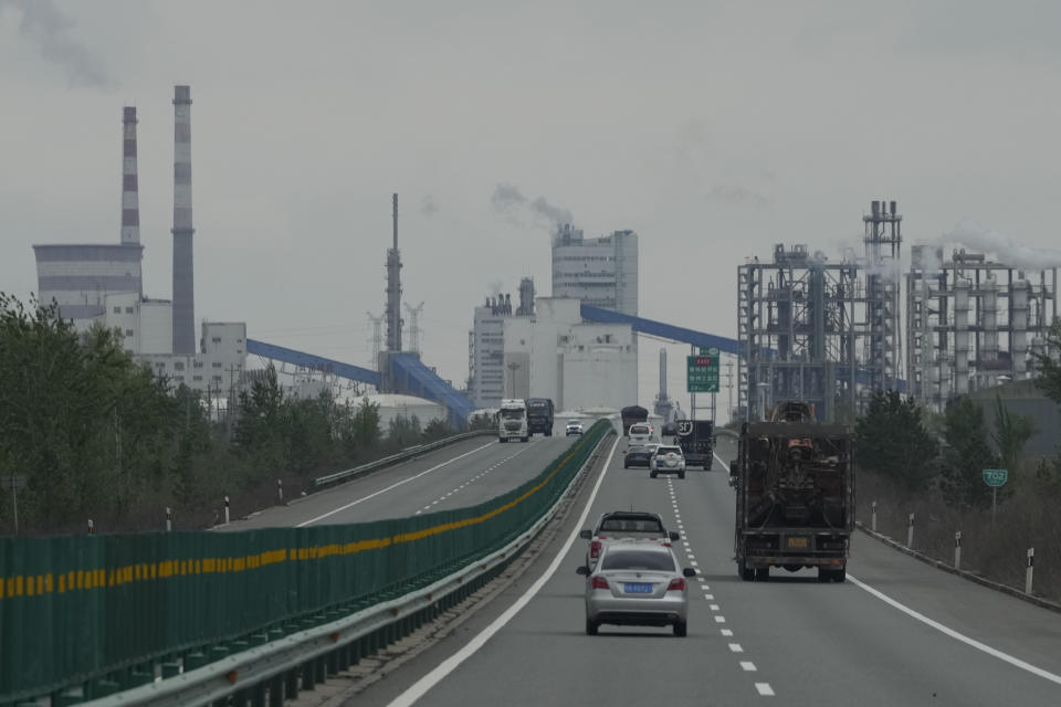 Smoking chimneys are seen along a highway in a coal producing region in Yulin in northwestern China's Shaanxi province, April 24, 2023. Energy security concerns, worsened by the war in Ukraine, and policy support from rich countries are likely to help investments in clean energy outpace spending on fossil fuels, the International Energy Agency said in a report issued Thursday, May 25, 2023. (AP Photo/Ng Han Guan)