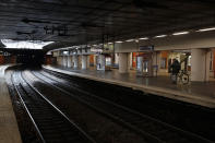 A passenger walks with his bicycle on empty platform of a RER suburb subway, in Paris, Sunday, Dec. 8, 2019 on the fourth day of nationwide strikes that disrupted weekend travel around France. (AP Photo/Francois Mori)