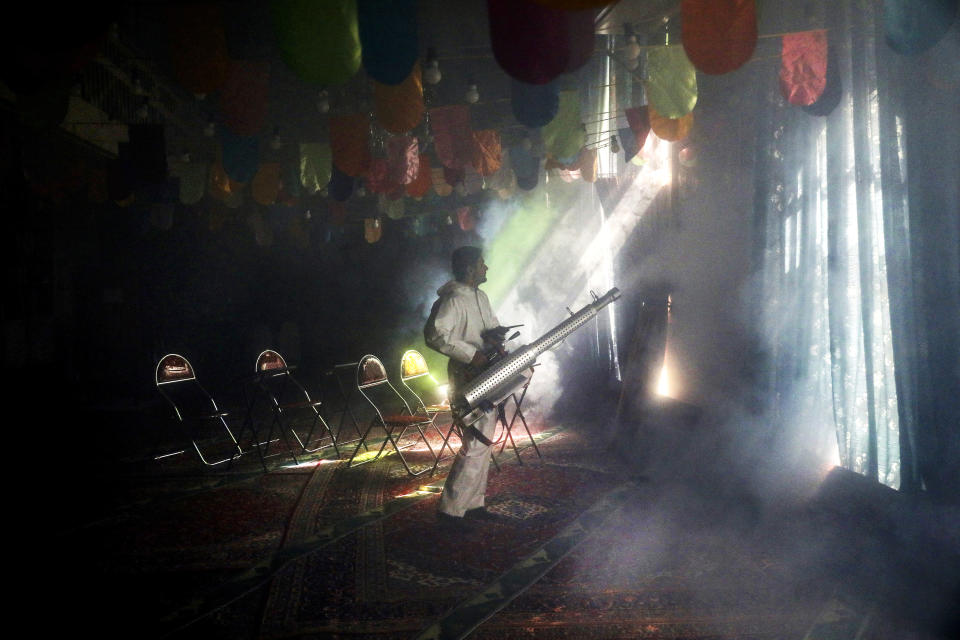 A firefighter disinfects a mosque to help prevent the spread of the new coronavirus in northern Tehran, Iran, Friday, March, 6, 2020. A Health Ministry spokesman warned authorities could use unspecified "force" to halt travel between major cities. (AP Photo/Ebrahim Noroozi)