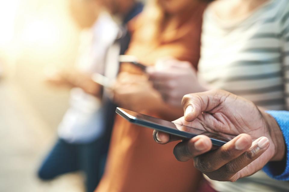 A group of people on their phones