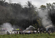 <p>Firefighters extinguish the flames that engulfed a Boeing 737 that plummeted into a yuca field with more than 100 passengers on board, in Havana, Cuba, Friday, May 18, 2018. (Photo: Enrique de la Osa/AP) </p>